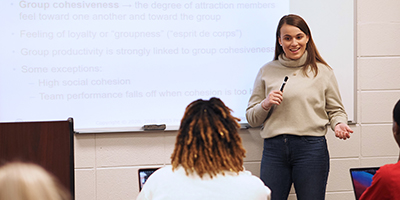 Student speaking in front of class.