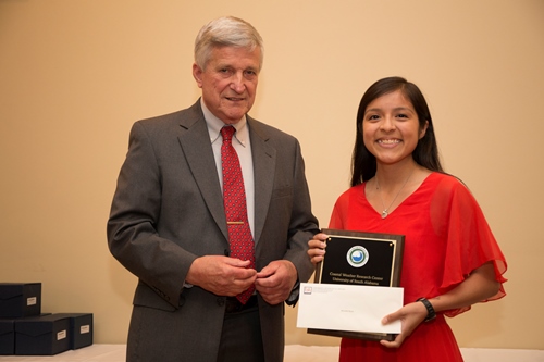 Dr. Bill Williams presents an Outstanding Senior Award to Meredith Wyatt.