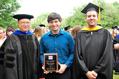 Michael Brown is congratulated by Dr. Keith Blackwell (left) and Andrew Murray.