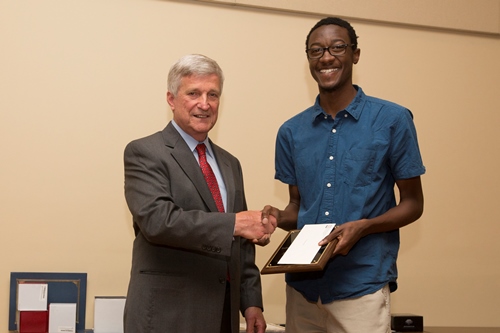 Dr. Bill Williams presents an Endowment Scholarship to Tommie Owens.