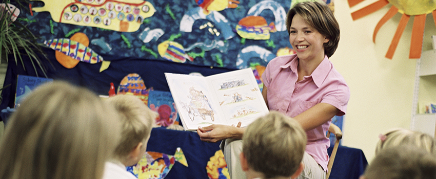 Teacher reading a book to the class.