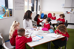 Teacher teaching young children in class