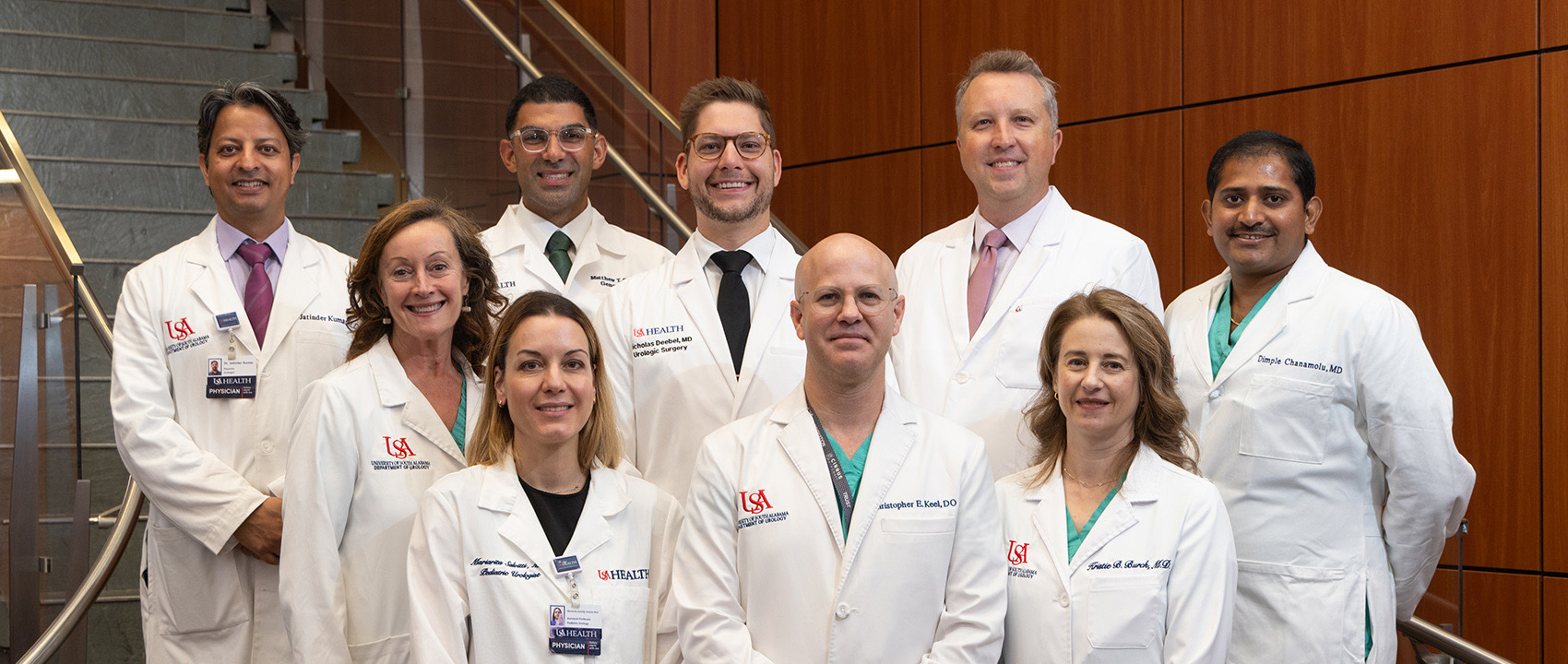 The faculty of the USA Department of Urology stand inside USA Health University Hospital.