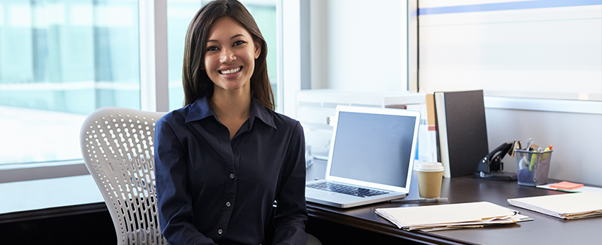 Girl smiling in front of desk