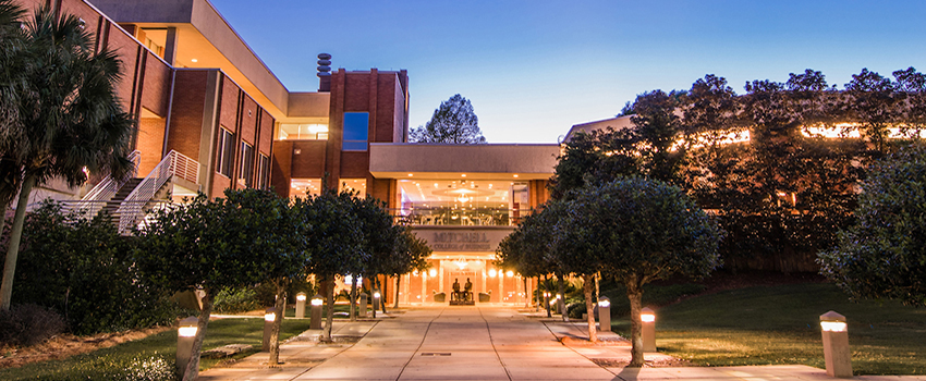 Mitchell College of Business at night.