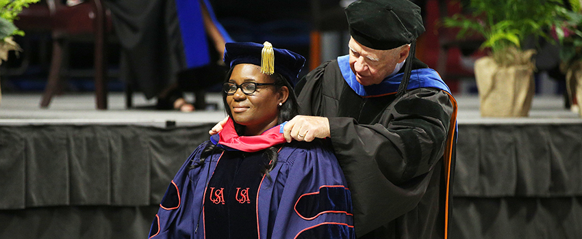 Spring Commencement with Student at graduation.