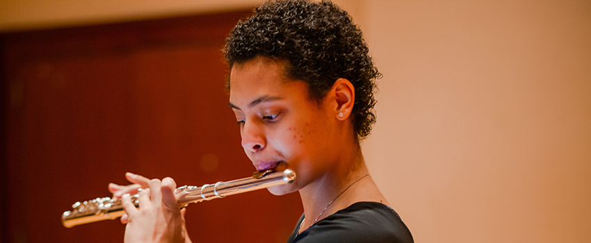 Student playing the flute.