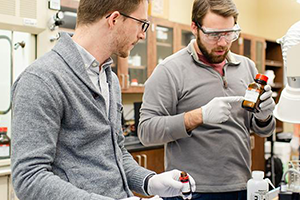 Two chemical engineering students working in classroom.