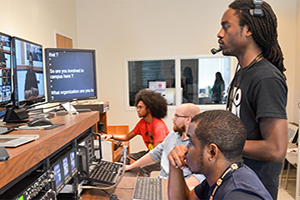 Students working in broadcast studio.