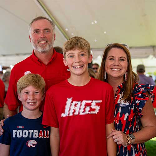 Kristin Odom and family at Homecoming alumi tent.