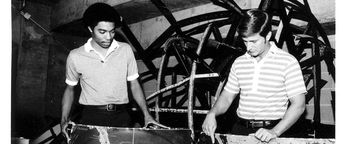 Dr. Bill Williams, right, and student Alfred Archer saw potential for the Waterman Globe to find a home on the University of South Alabama campus. It was moved from storage at the Mobile Municipal Auditorium, pictured here, to the University, where it was eventually restored. data-lightbox='featured'