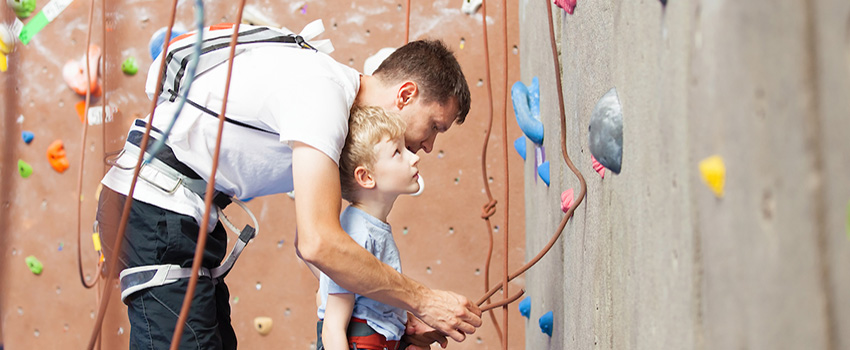 Father helping son with rockwall.