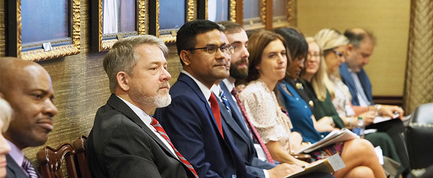 Members of USA Board listening at board meeting.