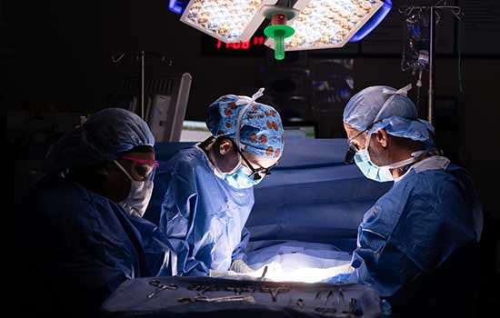 Doctors working on patient in surgery.