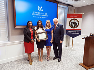 Miranda Powell with Dr. Kent, President Jo Bonner, and management team.
