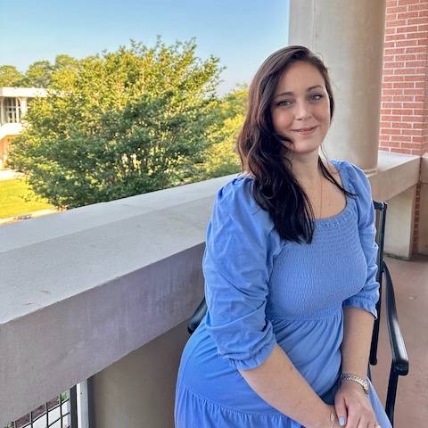 katherine sitting on chair on balcony