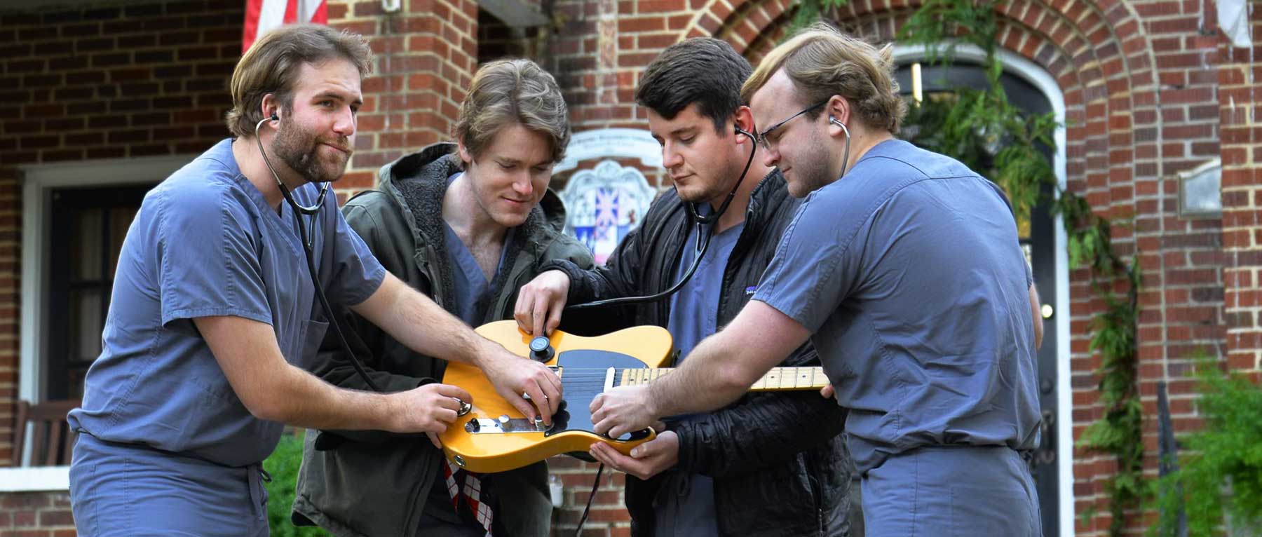 Members of the Grey Scrubs, one of five bands set to compete at the USA Health Doc Rock fundraiser on Jan. 30 at the Soul Kitchen in downtown Mobile. They are holding a guitar. 