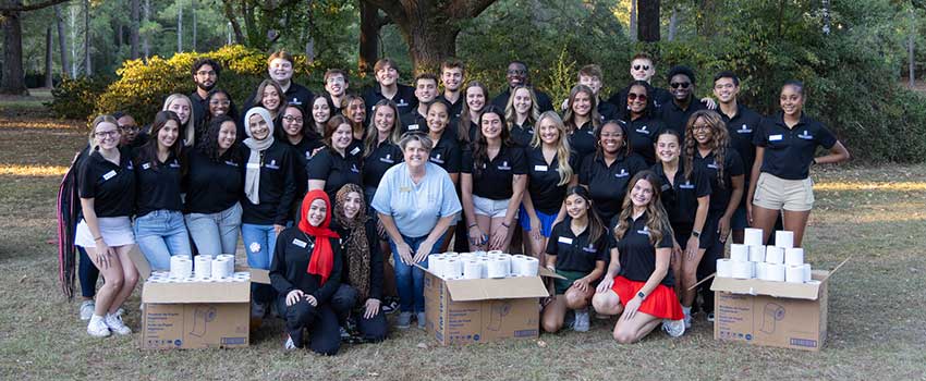 SGA officers outside with boxes of toilet paper.