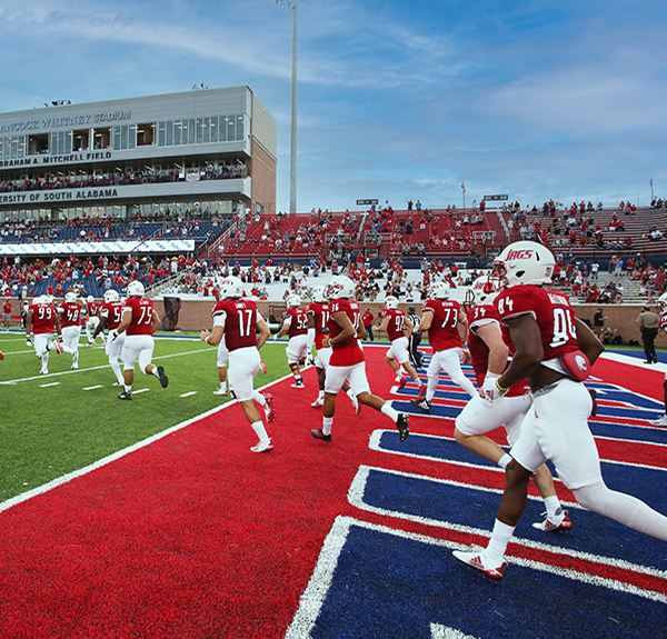 USA Football players running on the field.