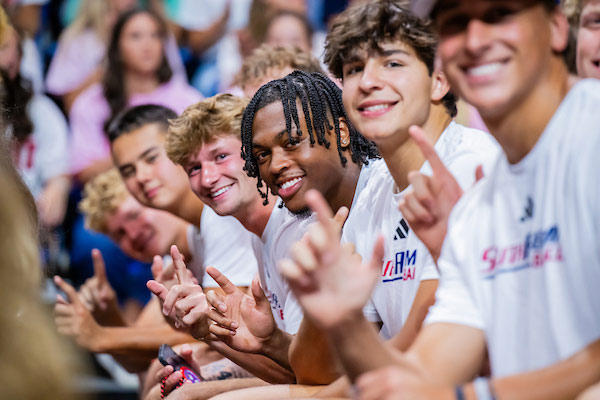 Students holding up J sign for Jaguars at convocation.