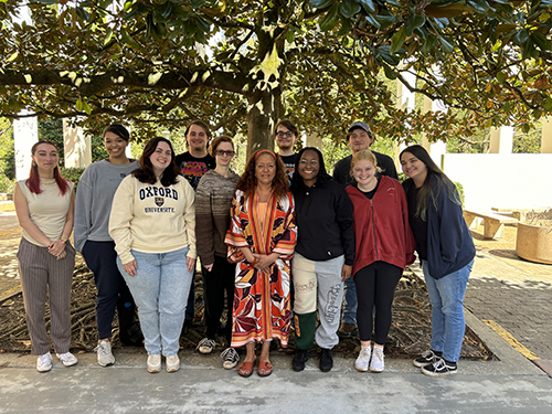 Undergraduate students who curated the exhibit with community advisor Valenia Green