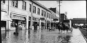 Horse Carriage riding through the flooded street.